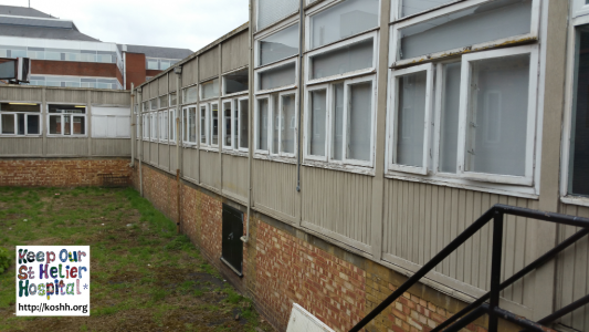 External view of corridor linking buildings in St George's hospital. Please note the single glazed, wooden framed windows.