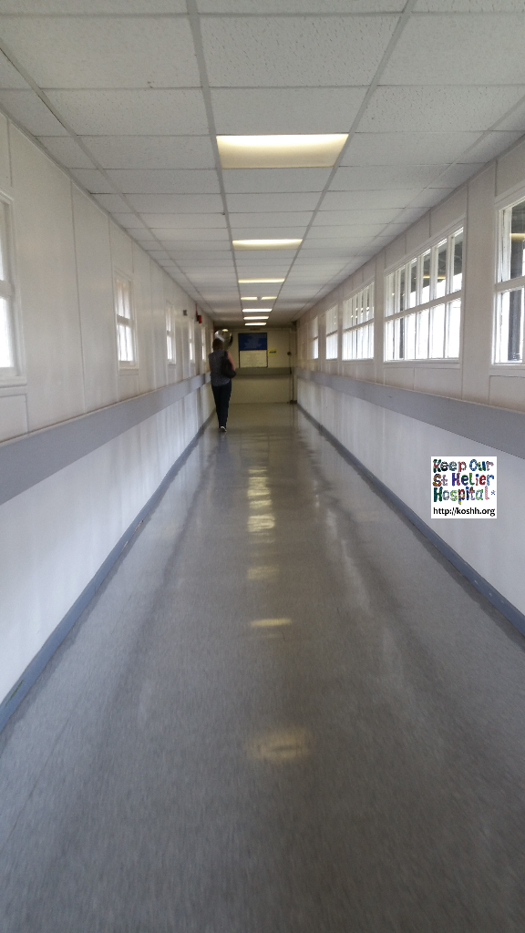 Corridor linking buildings in St George's hospital. Please note the single glazed, wooden framed windows.