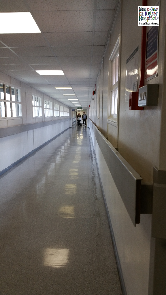 Corridor linking buildings in St George's hospital. Please note the single glazed, wooden framed windows.
